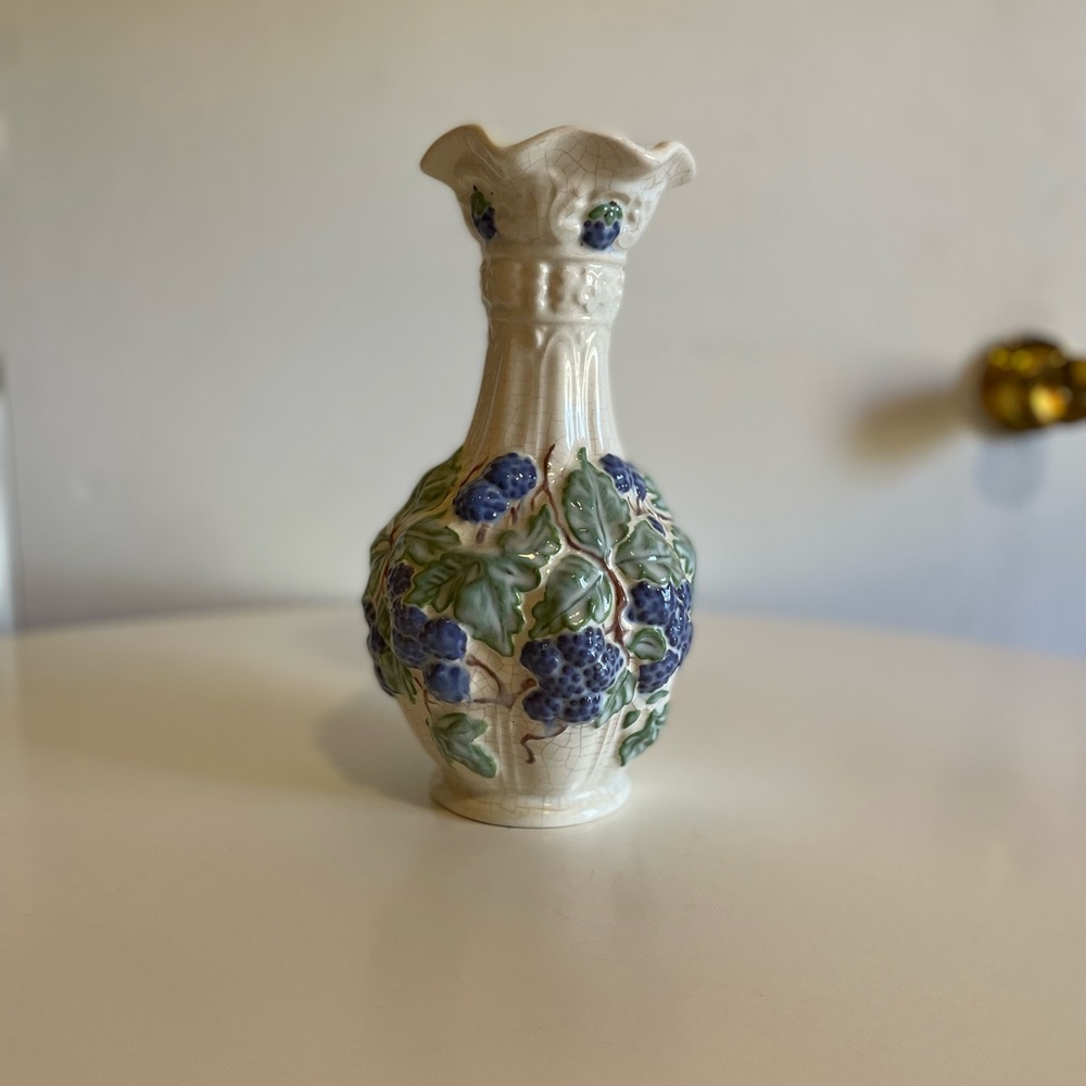 Vintage Ruffle mouth white pottery vase with grapevine design. No makers mark.
